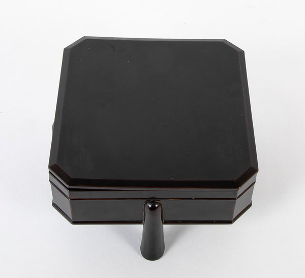 A Japanese Black Lacquer Faceted Covered Box on Four Splayed Feet