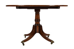 An Oval Regency Triple Banded Tilting Mahogany Breakfast Table