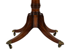 An Oval Regency Triple Banded Tilting Mahogany Breakfast Table