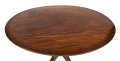 An Oval Regency Triple Banded Tilting Mahogany Breakfast Table