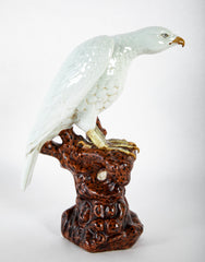 A Japanese White Glazed Porcelain Hawk Perched on a Tree Stump